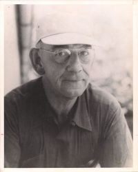 Gilbert Hedden sitting, wearing hat