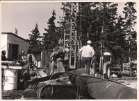 Group of workers around machine