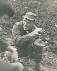 Blankenship smiling while talking to someone and posing with his hands
