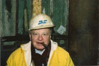 David Tobias in hard hat smoking cigar